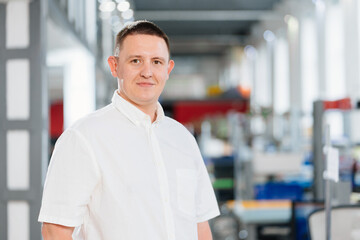 a man in a white shirt in the office. the portrait of an entrepreneur. career.