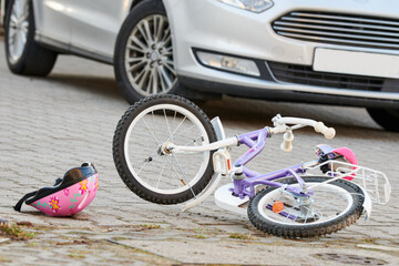 child bicycling helmet and bicycle near car during collision accident in the city - 571718465