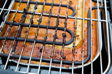 used dirty electric grill with burnt fat