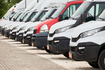 Fleet of commercial lorry trucks in row. Logistics and transportation service company
