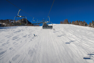 a chairlift leads over an almost deserted slope