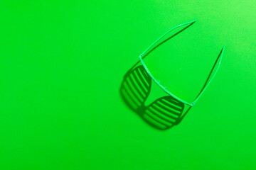 Image of green glasses and copy space on green background