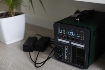 Fototapeta premium Charging station for gadgets when there is no light during blackout. Generator power bank battery in the absence of electricity. Charge electric rechargeable battery