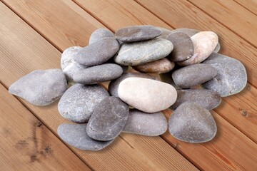 Fototapeta na wymiar Rocks, natural stones pile on wooden desk