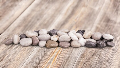 Fototapeta na wymiar Rocks, natural stones pile on wooden desk