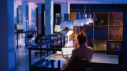 Executive manager creating business report at night, working after hours to develop new management strategy. Office employee planning financial project before deadline. Handheld shot.