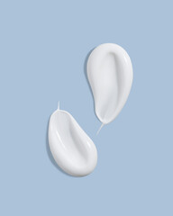 White beauty cream smears smudge on light blue background. Cosmetic skincare product texture. Face cream, body lotion swipe swatch