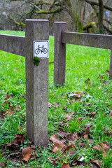 Parking lot for bicycles on green grass. Facilities for public bicycle parking for tourists and travelers. Vertical orientation.