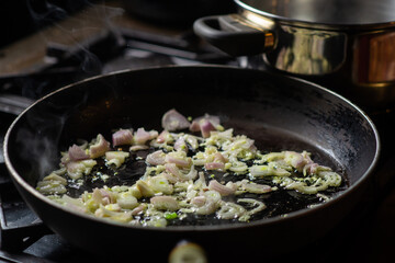 Onions are fried in a pan. Preparation for cooking.