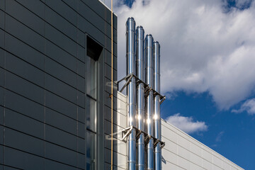 Gas heating turbo boiler. Part of the building heating system. Stainless steel metal pipes on the...