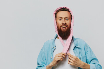 Funny man in a pink hat portrait on a light gray background. Smile and positive emotions.