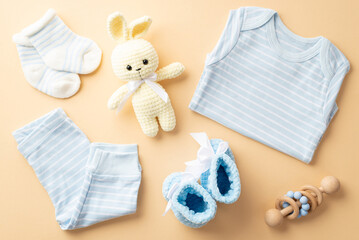 Baby shower concept. Top view photo of blue shirt pants knitted bunny toy tiny shoes socks and...