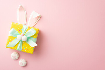 Easter concept. Top view photo of easter bunny giftbox with ears paws and muzzle on isolated pastel...
