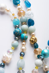 author trend necklace with different  beads  demonstrated  against white background. fashion and jewelry concept