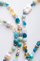 author trend necklace with different  beads  demonstrated  against white background. fashion and jewelry concept