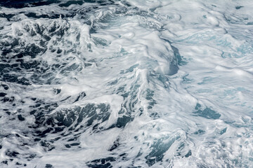 Sea foam appearing on the surface of the ocean.