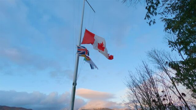 Canadian National Flag In The Wind. Blue Sunset Sky. Stanley Park, Downtown Vancouver, British Columbia, Canada. Slow Motion Cinematic