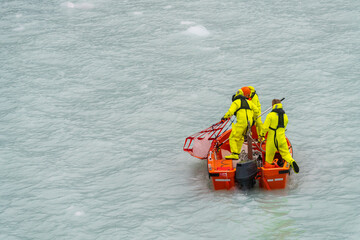 Fototapeta na wymiar Crew in small power boat collecting iceberg by Amalia Glacier in Patagonia and Chile