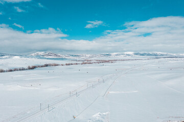 Fototapeta na wymiar beautiful sky and snowy train track