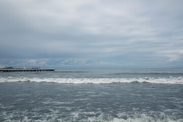 Picturesque view of sea with waves on cloudy day