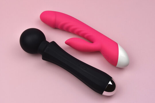 Black and fuchsia vibrators on a pink background, dildos prostate massager, clitoris stimulator, g-spot vibrators, accessories for adult sexual games, sex toys for adults