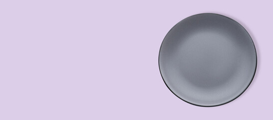 Empty gray ceramic plate on violet background, top view and space for text. Banner design
