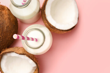 Obraz na płótnie Canvas Delicious vegan milk and coconuts on pink background, flat lay. Space for text