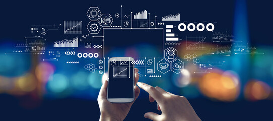 Digital transformation and technological revolution concept with person using a smartphone in a city at night