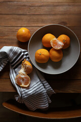Fresh ripe tangerines on wooden table, flat lay