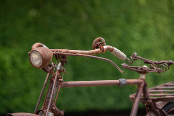 Old decay bicycle on green vine climbing garden wall outdoor. Rust Classic bike old bicycle on green garden wall retro style. Vine plant green leaves partition background.