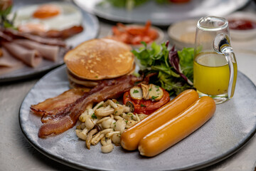 Mix dish Vegetarian breakfast salad with eggs Benedict, egg burrito, juice, toasted muffins, ham, poached eggs, and delicious buttery hollandaise sauce with fresh salad.