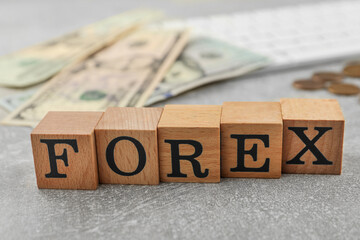 Word Forex made of wooden cubes with letters on grey table, closeup