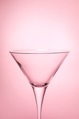 Elegant empty martini glass on pink background, closeup. Space for text