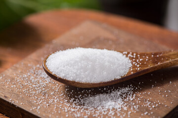 Fototapeta na wymiar close up of salt in wooden spoon on table