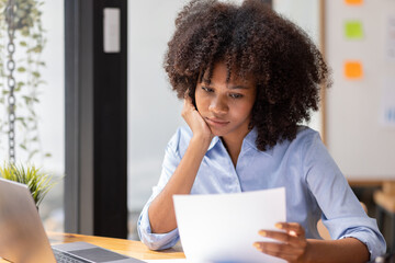 Young pensive female in afro hairstyle thinking of new creative ideas