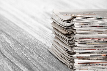 A pile of dusty, old magazines on background