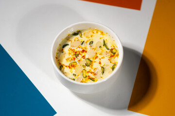 Almond-infused milk (‘badam milk’ or ‘badam doodh’), a traditional Ayurvedic recipe, served with saffron, pistachio, and almond slices.