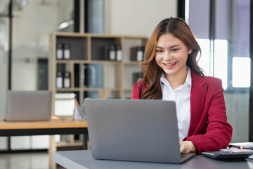 Business woman using calculator for do math finance on wooden desk in office and business working background, tax, accounting, statistics and analytic research concept.