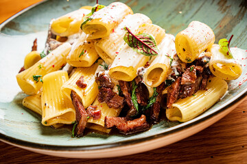 pasta with meat on the wooden background