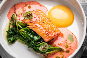 salmon steak with spinach and sauce