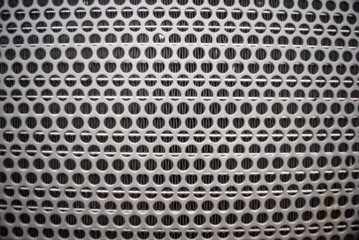 Metal with holes close up abstract detail background