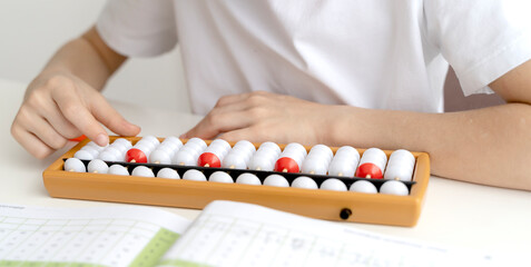 The boy is engaged in abacus, mental arithmetic for children