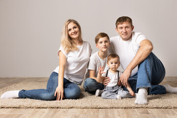 family with children on gray background