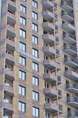 Fragment of the facade of a multi-storey residential building on a winter day