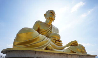 Golden Buddhist statues and carving showing intricate details and textures created by Buddhist...