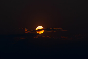 The orange moon, also known as the harvest moon or the hunter's moon, over the night sky at Sikkim,...