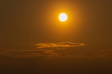 Rise of the orange moon, also known as the harvest moon or the hunter's moon, over the night sky at...