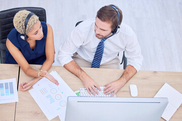 Call center, collaboration and overhead with a woman supervisor training a man employee in a...