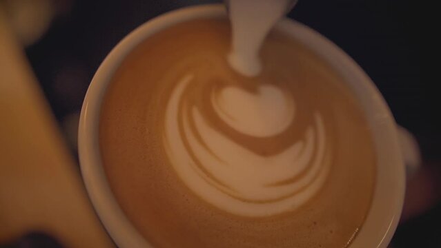 garnishing a cappuccino with cream