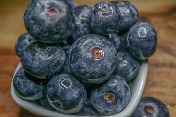 blueberries with yogurt on a black plate